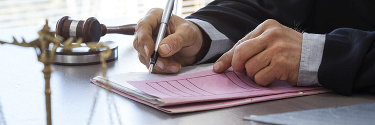 Scales of justice with judge gavel on table
