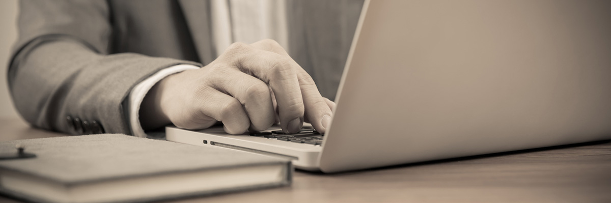 Hands of a man working with laptop